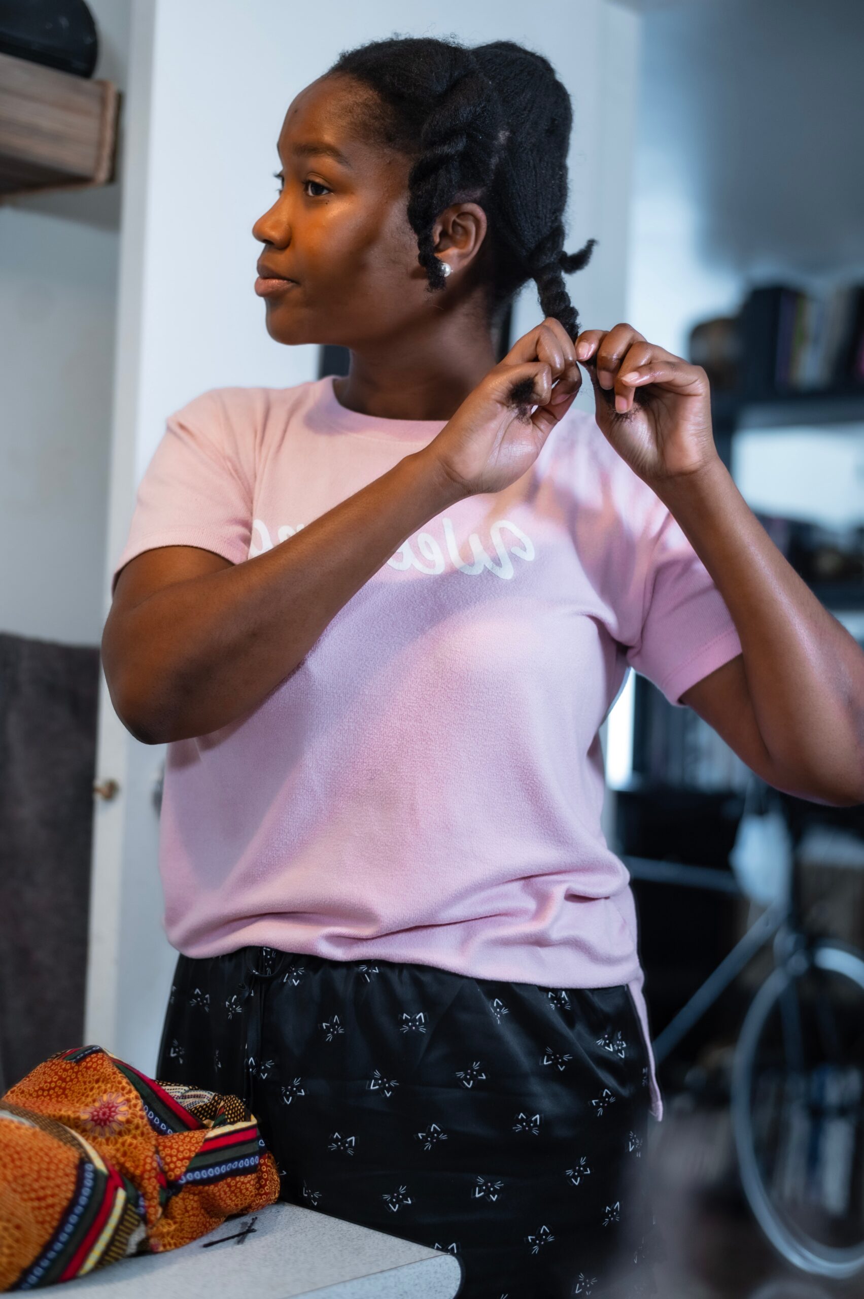 Woman of colour fixing hair