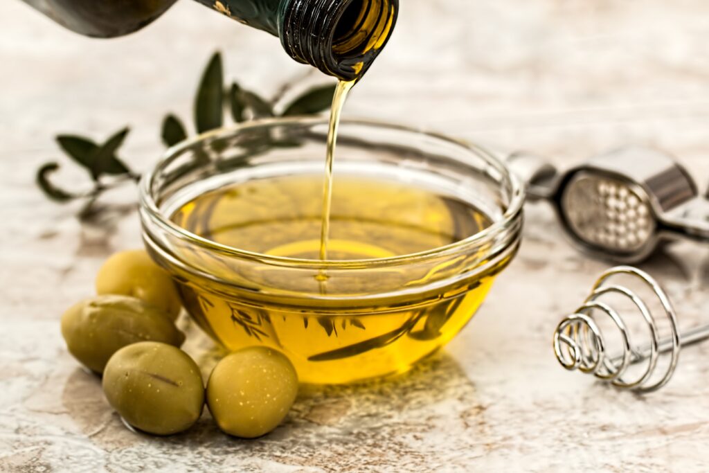 Glass bowl of olive oil, type 4 hair