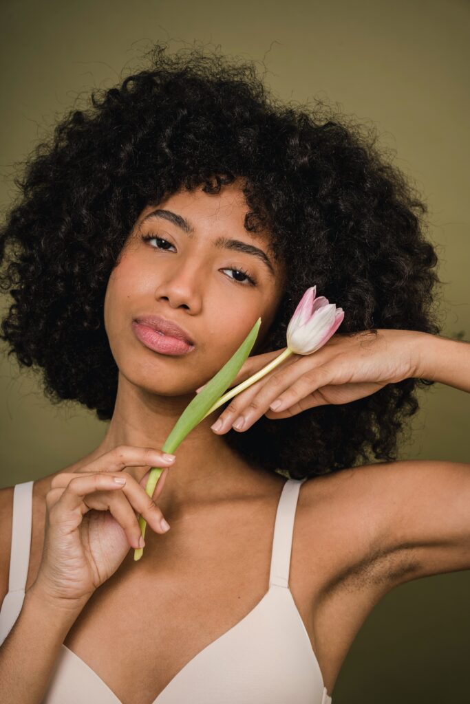 type 4 hair girl, 4A hair, headshot holding flower